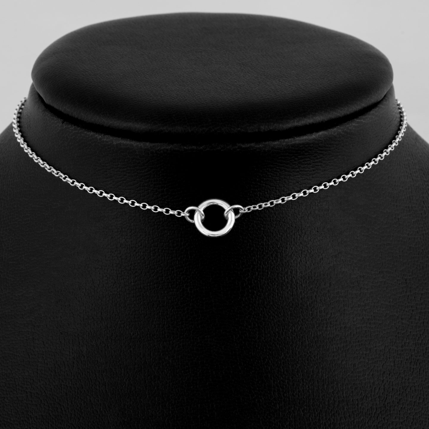 Silver day collar consisting of a delicate silver chain with a tiny 10mm diameter O ring suspended in the centre. The O ring is made of 1.8mm thick silver wire.