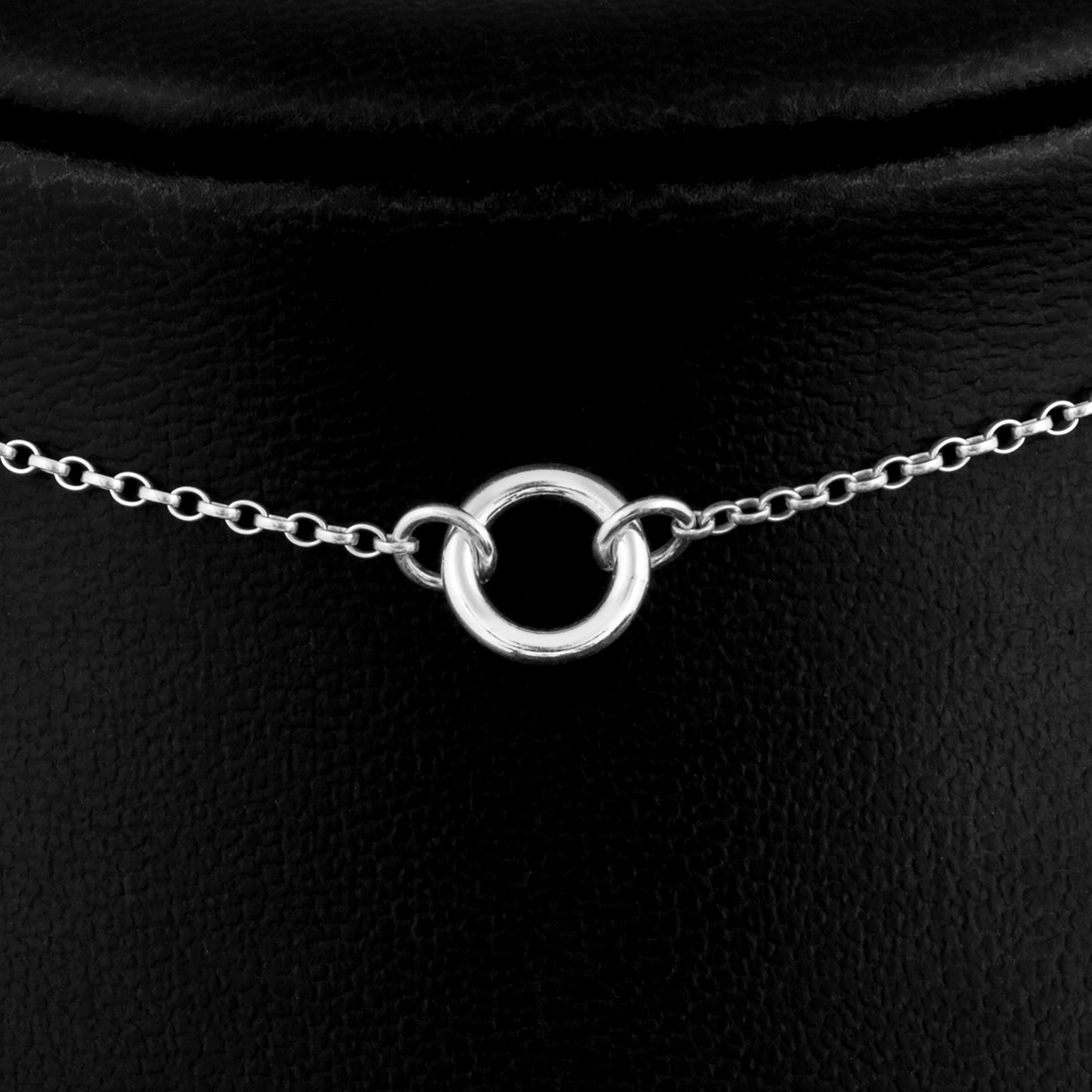 Close up picture of Silver day collar consisting of a delicate silver chain with a tiny 10mm diameter O ring suspended in the centre. The O ring is made of 1.8mm thick silver wire.