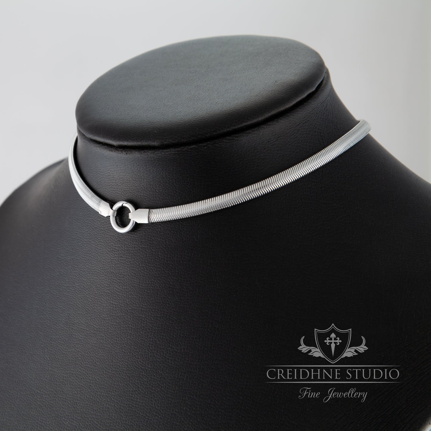 Silver choker necklace on a black mannequin with 'Creidhne Studio' branding.