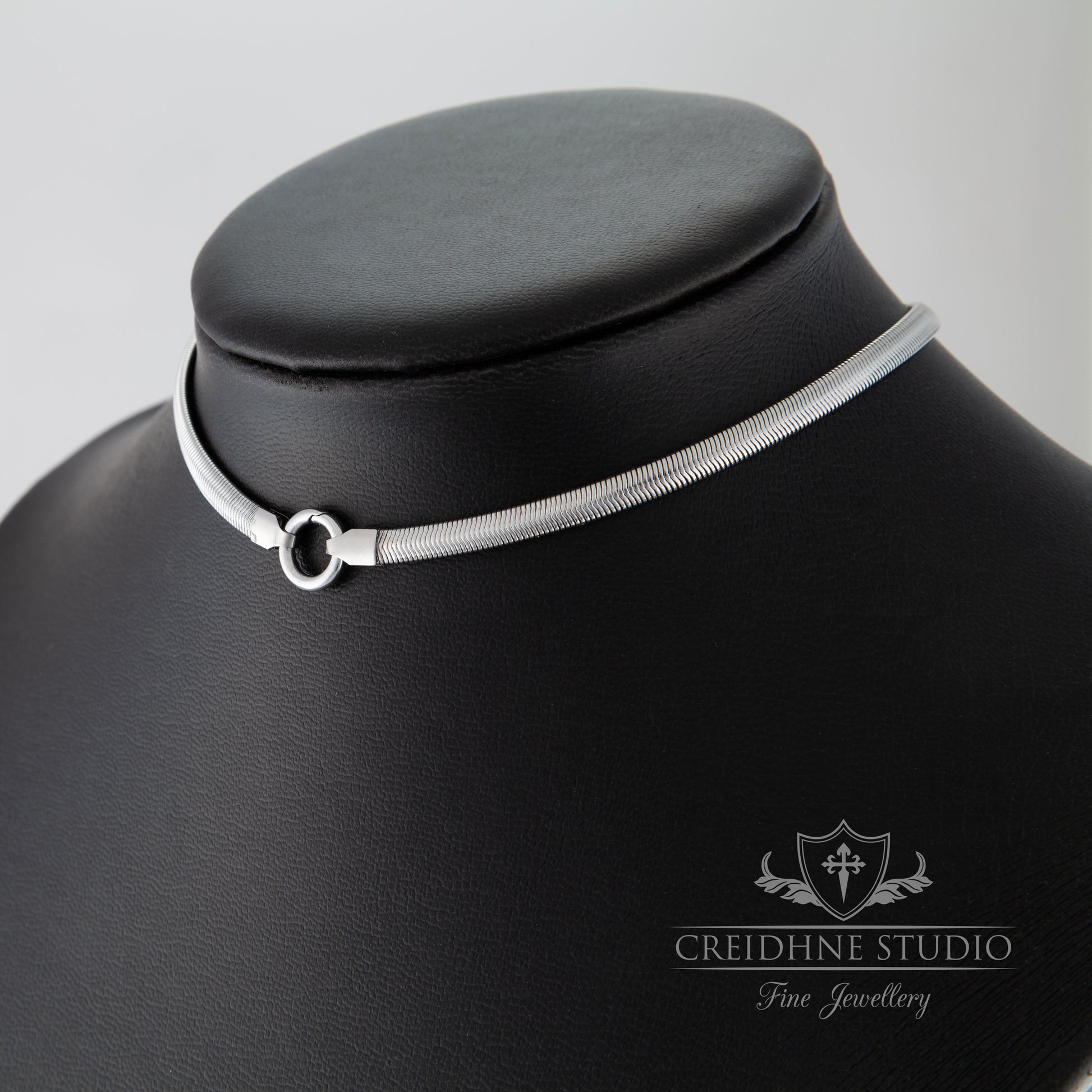 Silver choker necklace on a black mannequin with 'Creidhne Studio' branding.