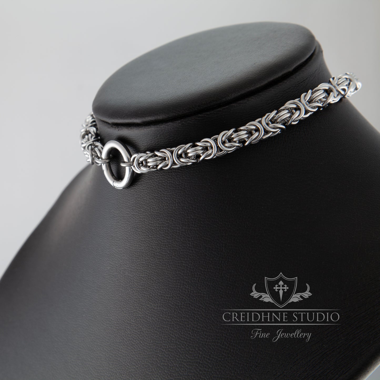 Silver chain choker necklace on a black mannequin bust with Creidhne Studio logo.