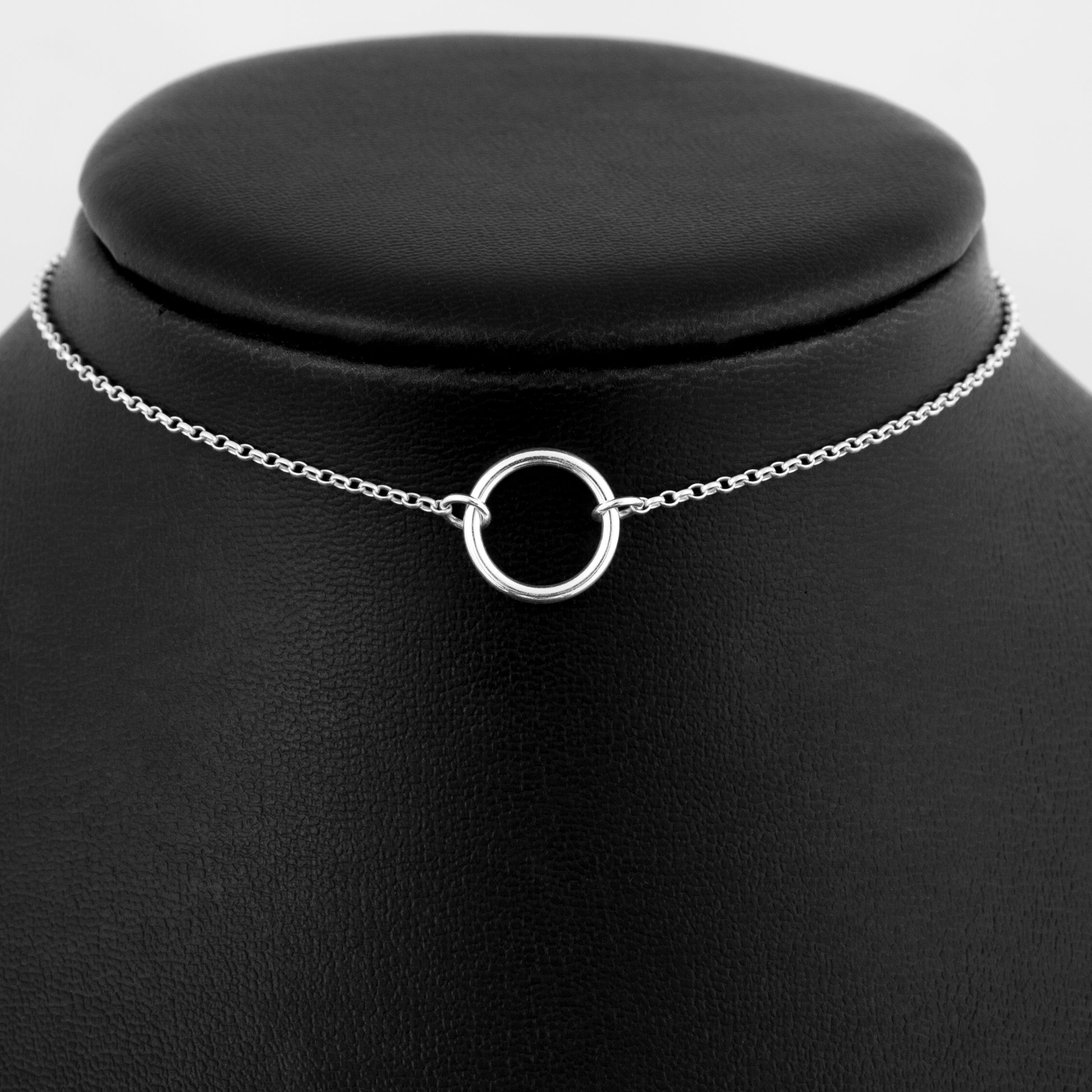 Silver day collar consisting of a delicate silver chain with a small 15mm diameter O ring suspended in the centre. The O ring is made of 1.8mm thick silver wire.