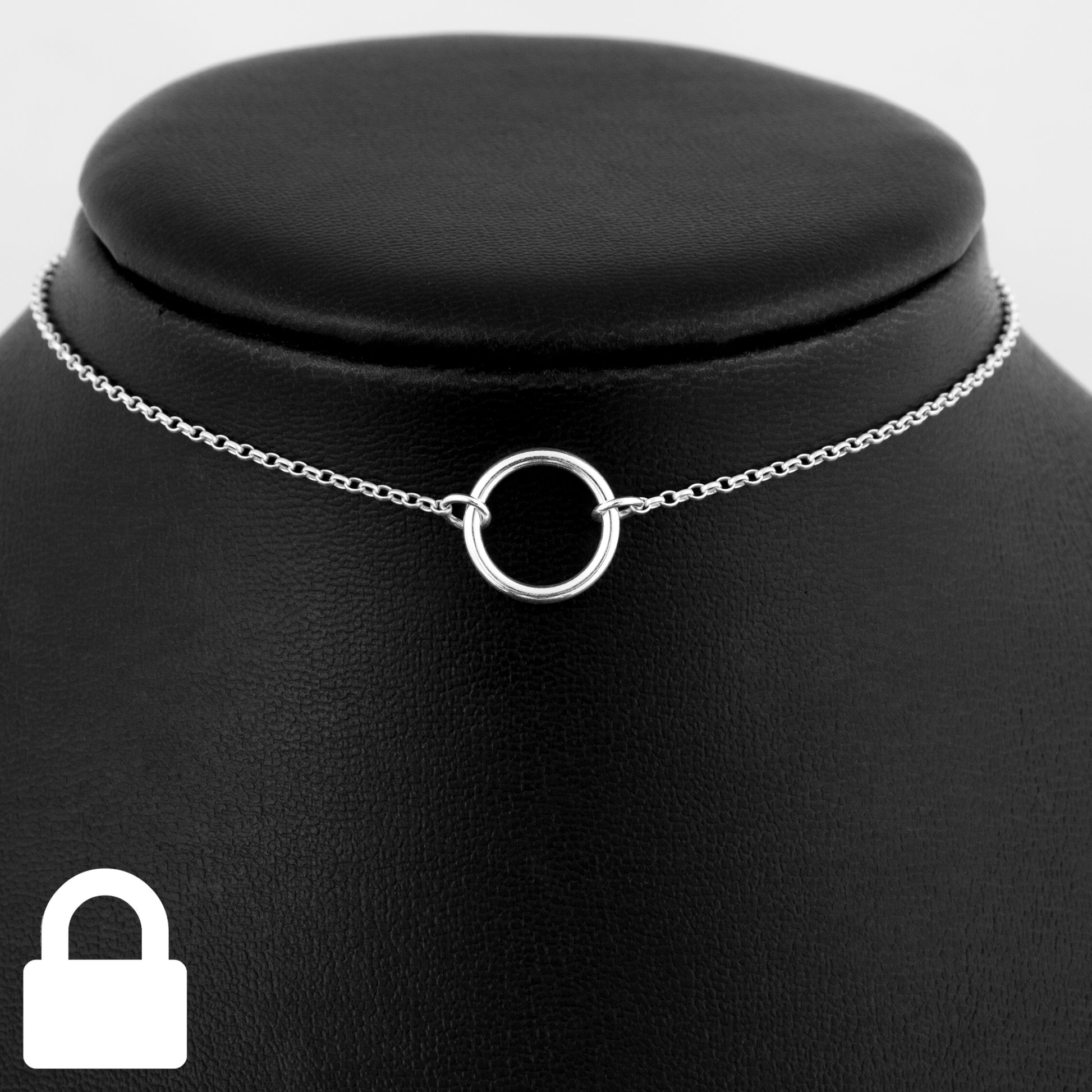 Permanently locking silver day collar consisting of a delicate silver chain with a small 15mm diameter O ring suspended in the centre. The O ring is made of 1.8mm thick silver wire.