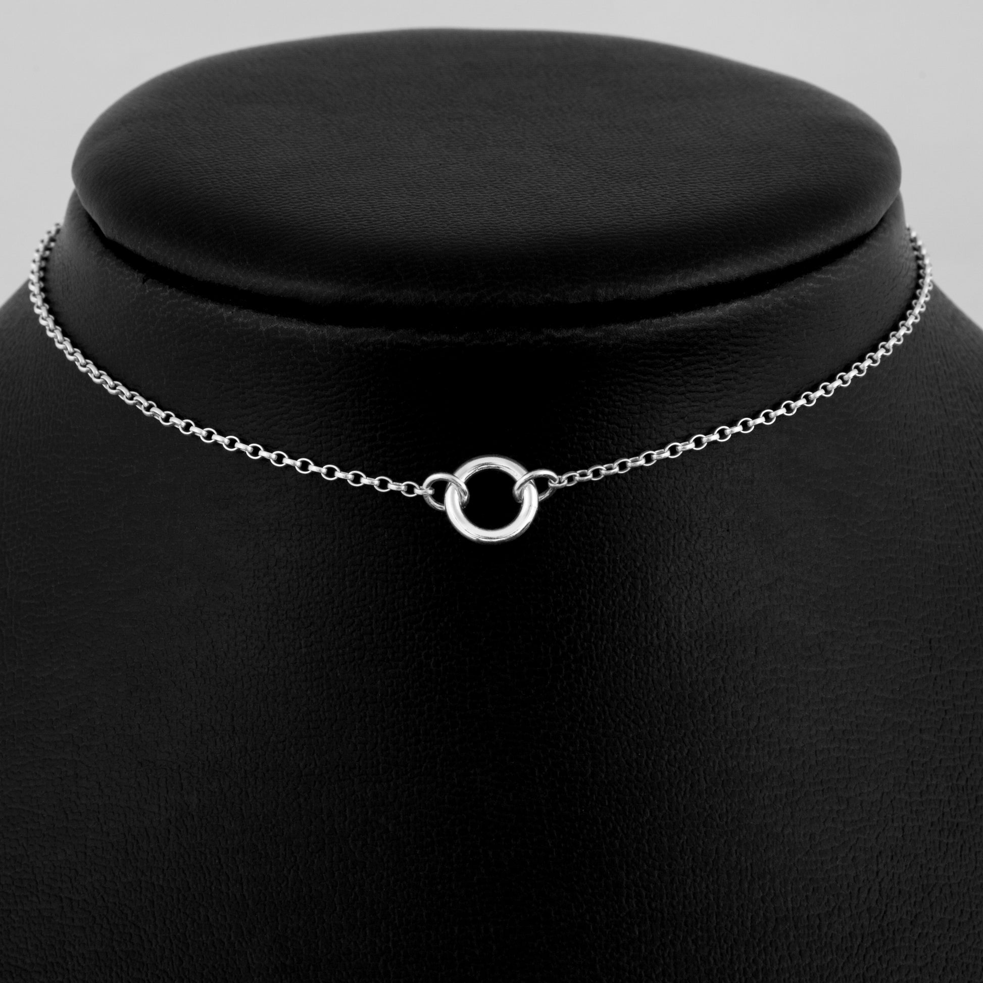 Silver day collar consisting of a delicate silver chain with a tiny 10mm diameter O ring suspended in the centre. The O ring is made of 1.8mm thick silver wire. 