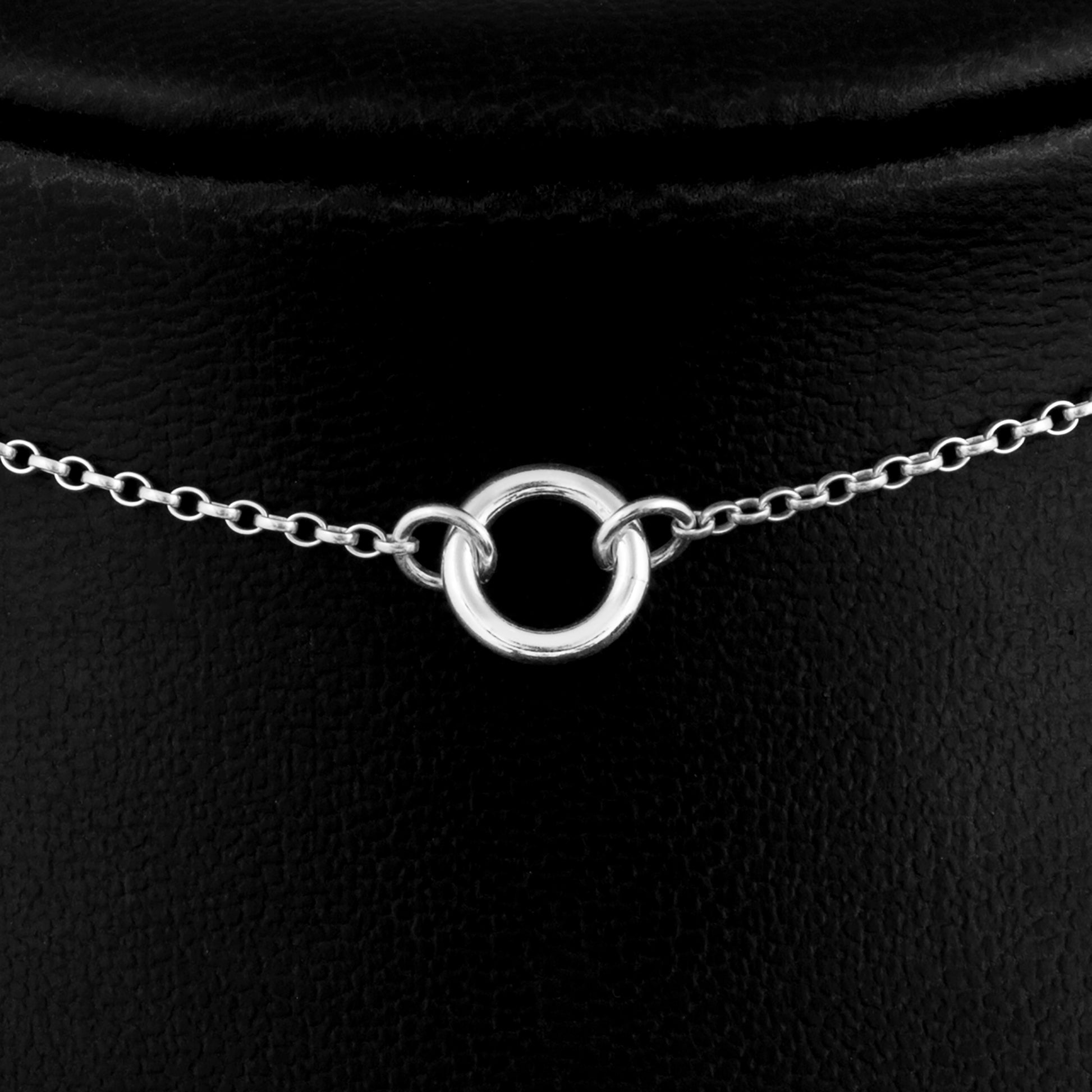 Close up picture of Silver day collar consisting of a delicate silver chain with a tiny 10mm diameter O ring suspended in the centre. The O ring is made of 1.8mm thick silver wire. 