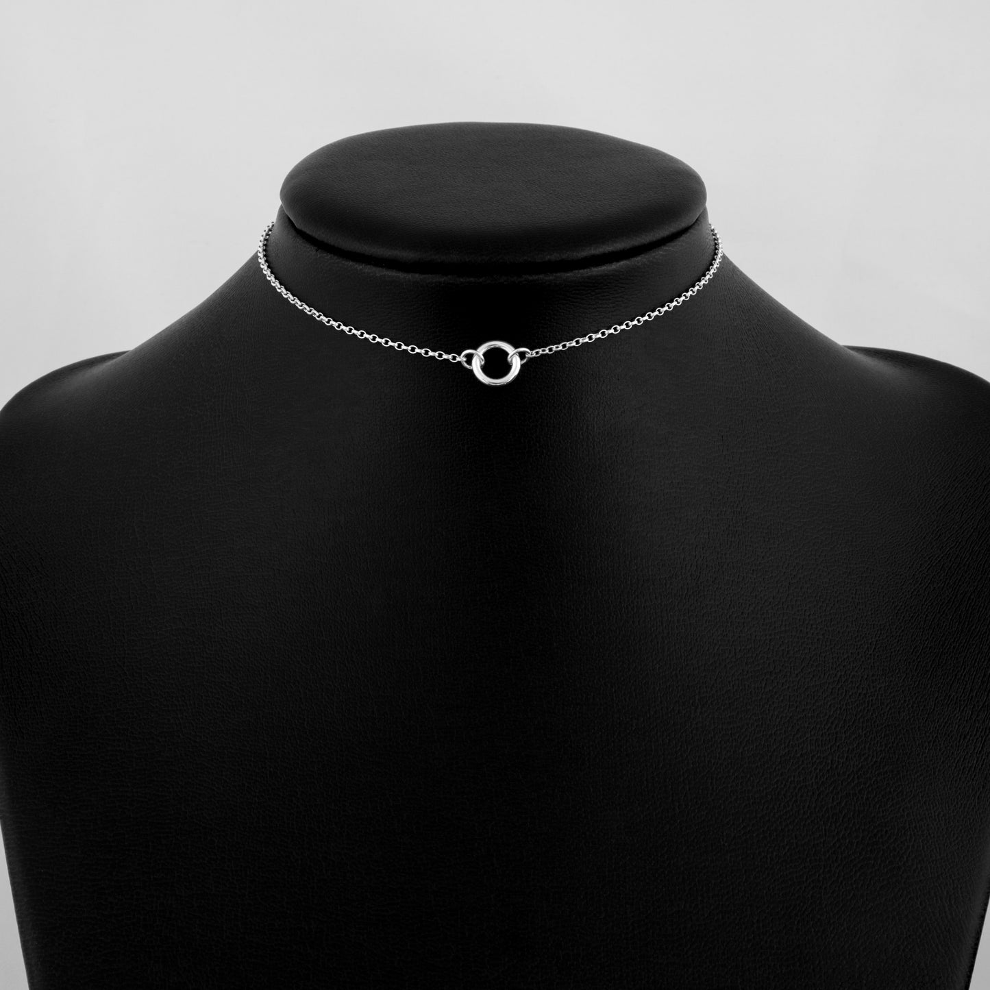 Silver day collar consisting of a delicate silver chain with a tiny 10mm diameter O ring suspended in the centre. The O ring is made of 1.8mm thick silver wire. 