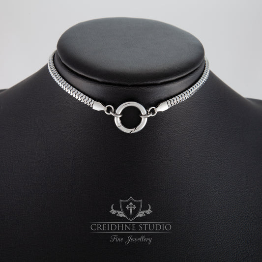 Silver necklace on a black mannequin with 'Creidhne Studio' branding.
