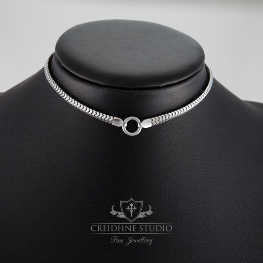 Silver necklace on a black mannequin with 'Creidhne Studio' branding.
